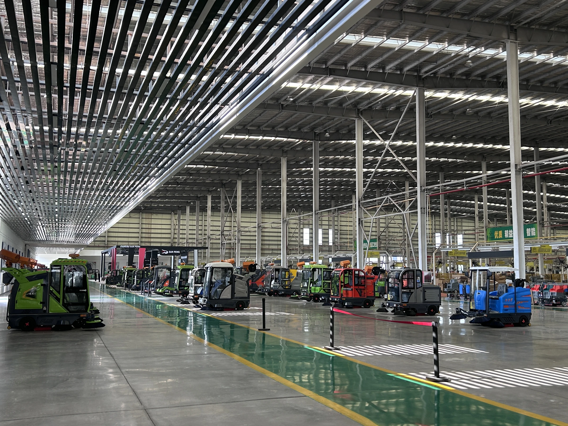 Electric sweepers displayed across the production workshop